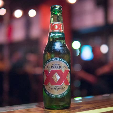 Download Dos Equis Beer Bottleon Bar Wallpaper | Wallpapers.com