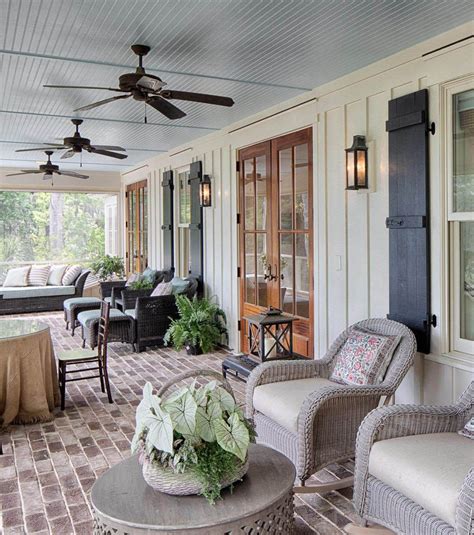 Wood french style front doors with a covered porch, lots of seating ...