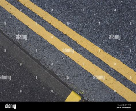 double yellow line no parking road marking sign Stock Photo - Alamy
