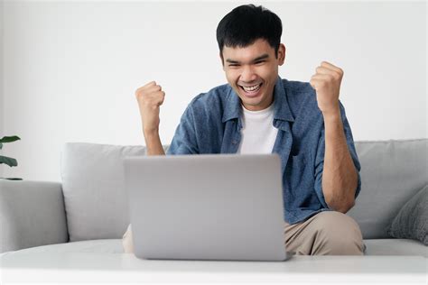 Happy excited Asian man looking at laptop, man receiving good news ...
