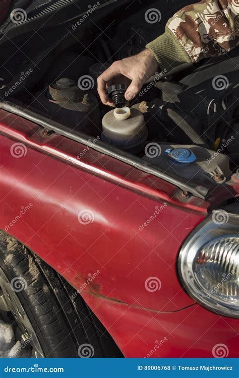 Steering Fluid Change. the Mechanic Fills the Tank Power Steering Fluid ...