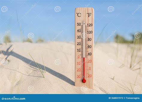 Wooden Celsius And Fahrenheit Scale Thermometer In The Sand. Ambient ...