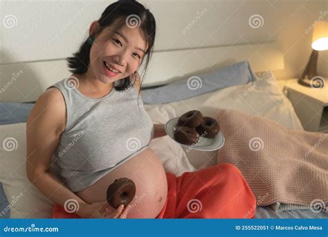 Young Happy and Beautiful Asian Japanese Woman Pregnant Sitting on Bed ...