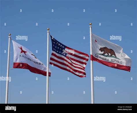 Flags of California and the United States of America against a clear blue sky as seen in Santa ...