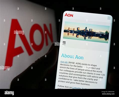 Person holding smartphone with website of financial services company ...