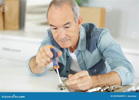 Senior Man Screwing Hinge To Cupboard Door Stock Image - Image of door ...