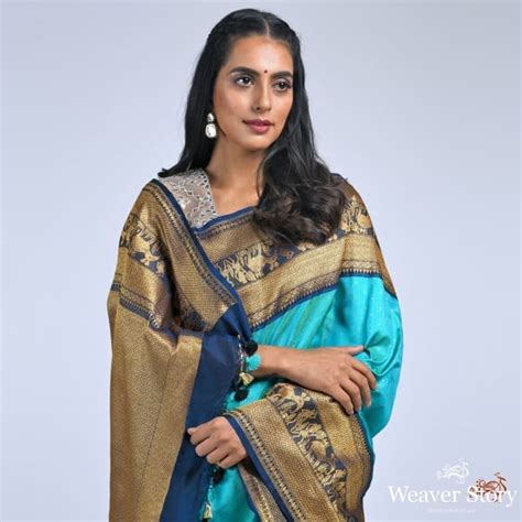Teal green ektara saree with navy border with warli art weave – WeaverStory