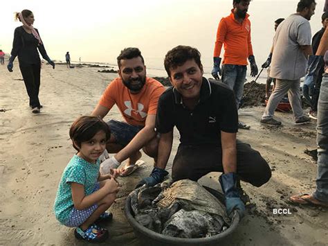 Volunteers take part in a clean-up drive at Versova beach in Mumbai ...