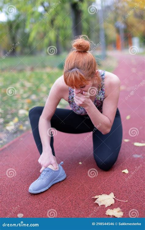 Redhaed Woman in Sportswear with Painful Ankle Injury on Running Track ...
