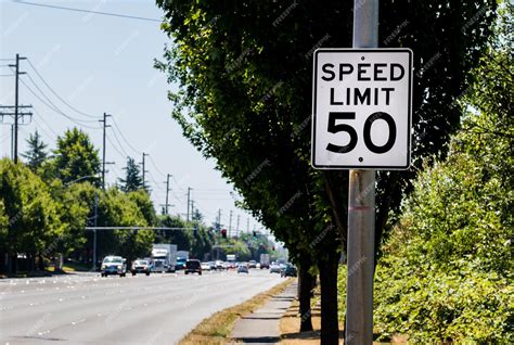 Premium Photo | 50 mph speed limit sign on post with a road and tree