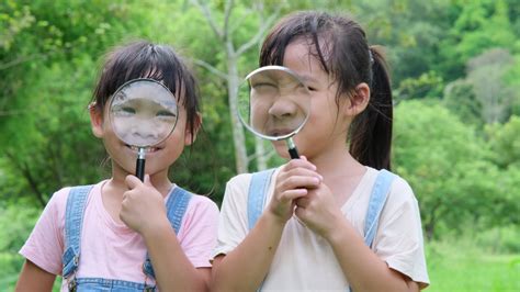 Children learn and explore nature with an outdoor magnifying glass ...