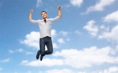 Happy young man jumping over white background | Premium Photo