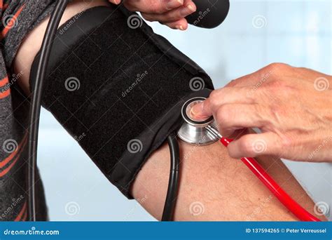 Doctor Measures the Blood Pressure with Stethoscope Stock Image - Image ...