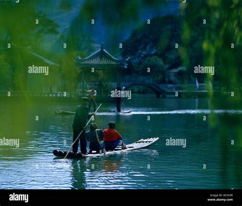 3 men on boat in water Stock Photo - Alamy