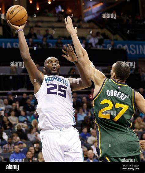 Charlotte Hornets' Al Jefferson (25) shoots over Utah Jazz's Rudy ...