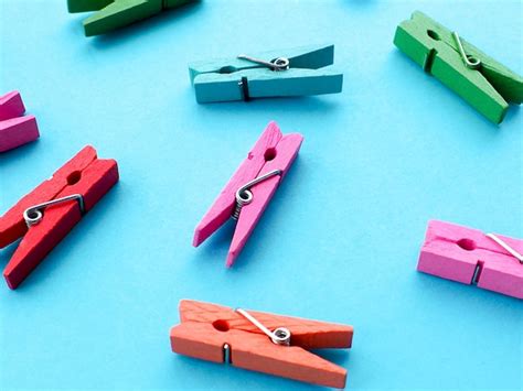 Many colored clothespins on a blue background | Premium Photo