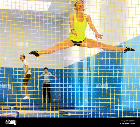 Female gymnast jumping on trampoline Stock Photo - Alamy