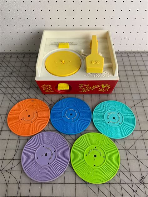 VINTAGE FISHER PRICE RECORD PLAYER AND RECORDS - Schmalz Auctions