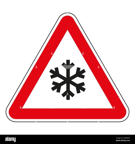 Red triangle road sign warning about ice or snow on the road ...