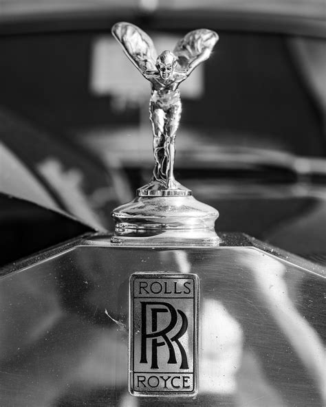 A black and white photo of a rolls royce emblem photo – Free The spirit of ecstasy Image on Unsplash