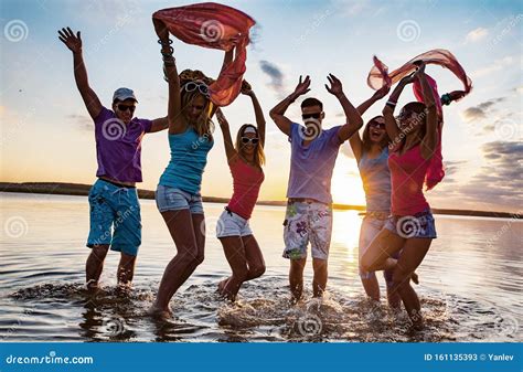 Teens beach party stock image. Image of celebrate, sunset - 161135393