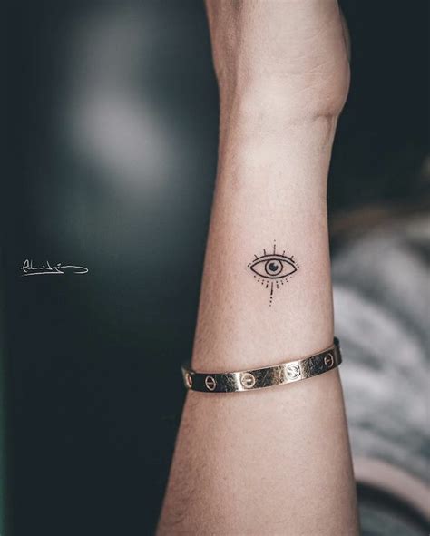 https://www.ourmindfullife.com/wp-content/uploads/2021/10/Evil-eye-small-wrist-tattoo-by-%40edgomz.jpg