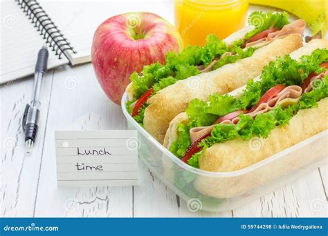 Lunch Box with Ciabatta Bread Sandwiches, Apple and Orange Juice Stock ...