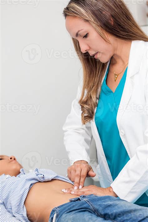 Doctor examining and performing the technique of abdominal percussion ...