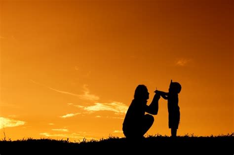 Premium Photo | Silhouette of a mother and son playing outdoors at sunset