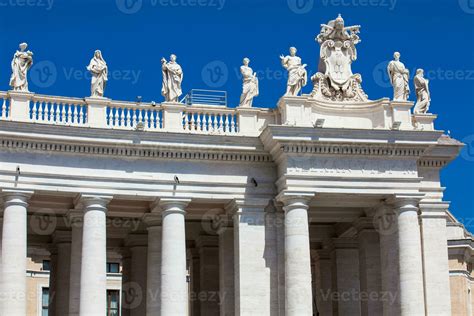 Detail of the Chigi coats of arms and the statues of saints that crown the colonnades of St ...