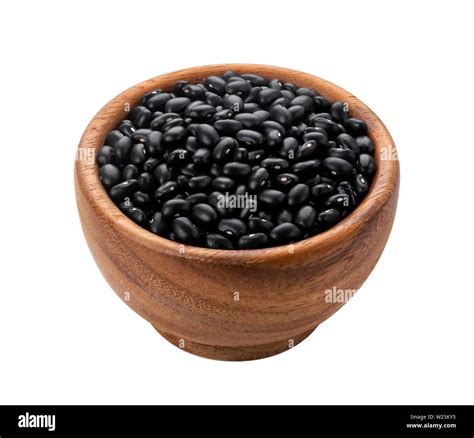 Brown wooden bowl with dried black beans Stock Photo - Alamy