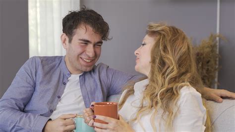 Mature mother and her loving son are chatting. Mother and son sitting ...