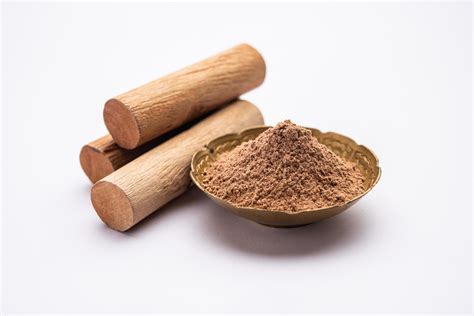 Chandan or sandalwood powder with sticks, perfume or oil which retain ...