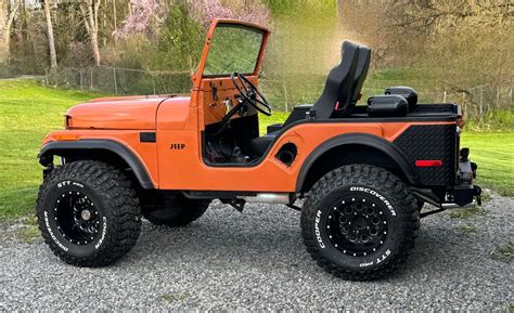 Orange Jeep on Gravel Road