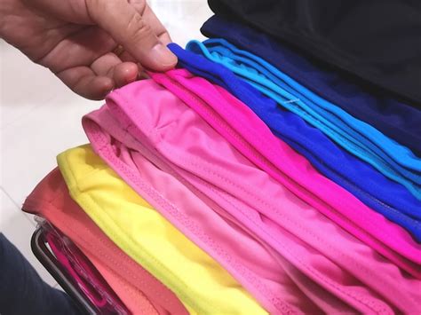 Hand picking colorful swimming protective caps at sport store | Premium ...