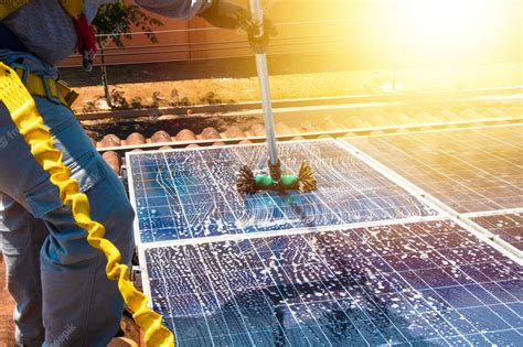Premium Photo | Solar worker cleaning photovoltaic panels with brush ...
