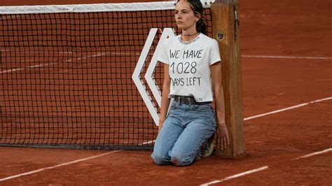 1028 days left: Climate protester ties herself to net during French ...