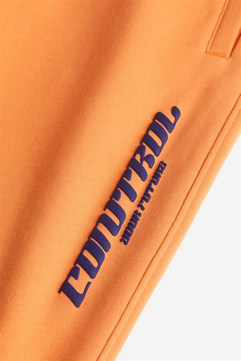 Loose Fit Sweatpants - Orange/Control Your Future - Men | H&M IN