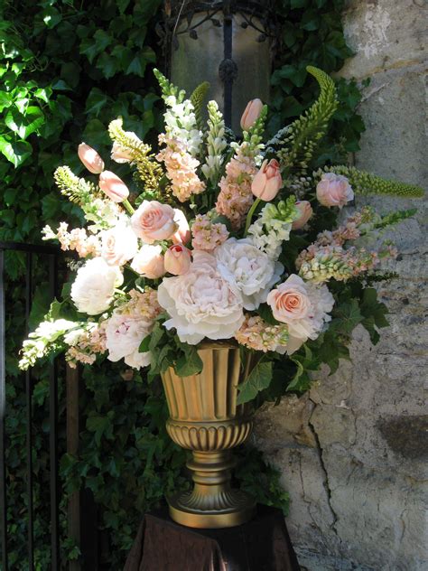 Ceremony Decor: A large urn arrangement in soft pinks, peachy blushes ...