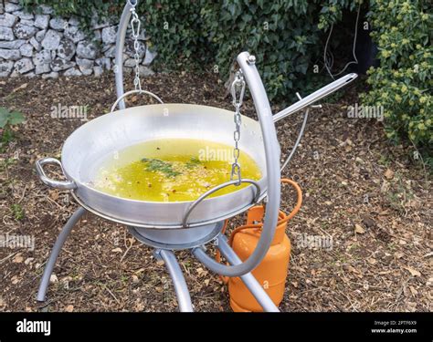 Chopped Garlic and onion frying with olive oil in a big frying pan ...