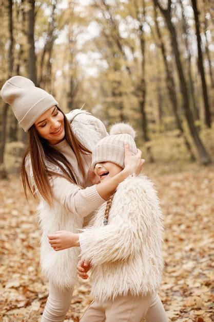 Young woman with little girl walking in autumn forest. brunette woman ...