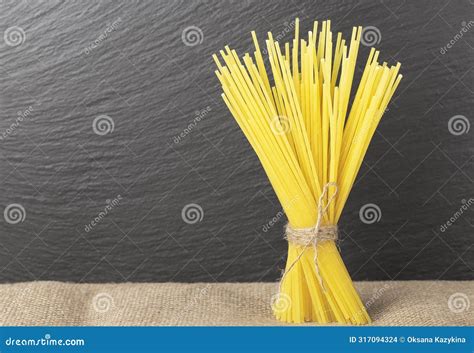 Raw Spaghetti Pasta from Durum Wheat Vertically on a Dark Background ...