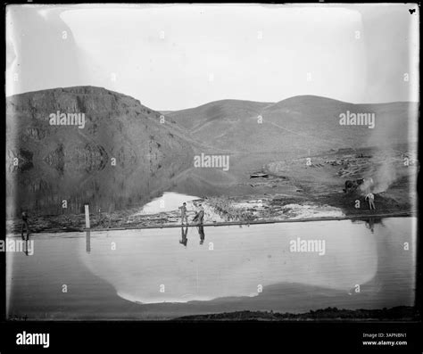 This photograph by Lee Moorhouse captures construction scenes at Coe Dam and Furnish Reservoir ...
