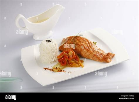 Close-up on salmon fillet with fruit salsa, over rice.