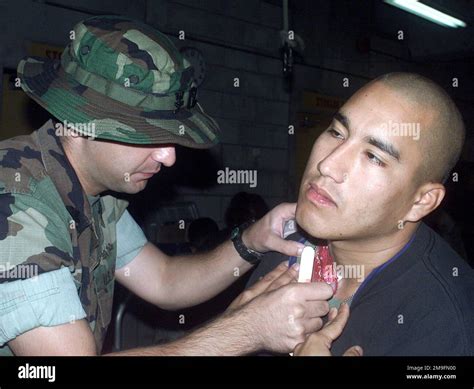 Hospital Corpsman Second Class Tayyab applies some pressure to a neck ...