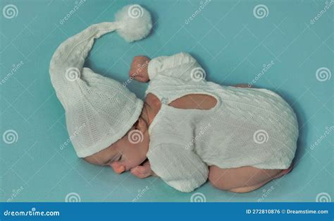 Newborn Baby Boy Wearing Knitted Pants and Hat Sleeping on His Tummy ...