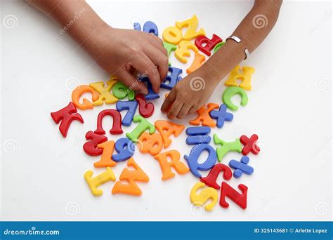 Hands of Mom and Daughter Play with the Game of Colored Letters As ...