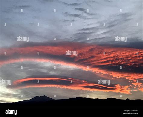 Red sky at dawn over mount Teide. Lenticular clouds glowing red ...