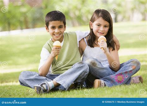 Two Children Eating Ice Cream in Park Stock Image - Image of diet ...