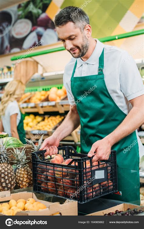 Shop assistant in grocery shop — Stock Photo © ArturVerkhovetskiy ...